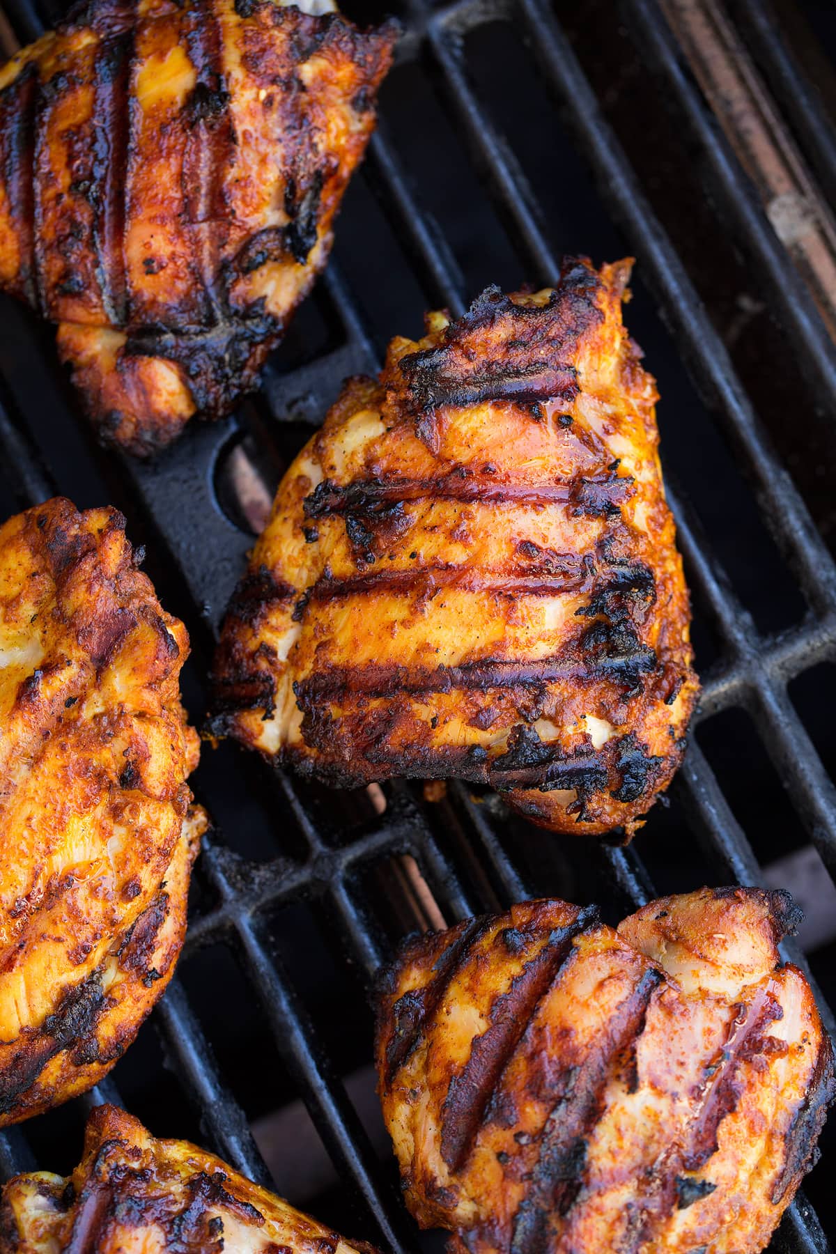 Tandoori Chicken 5 pieces of Tandoori Chicken shown on a grill.
