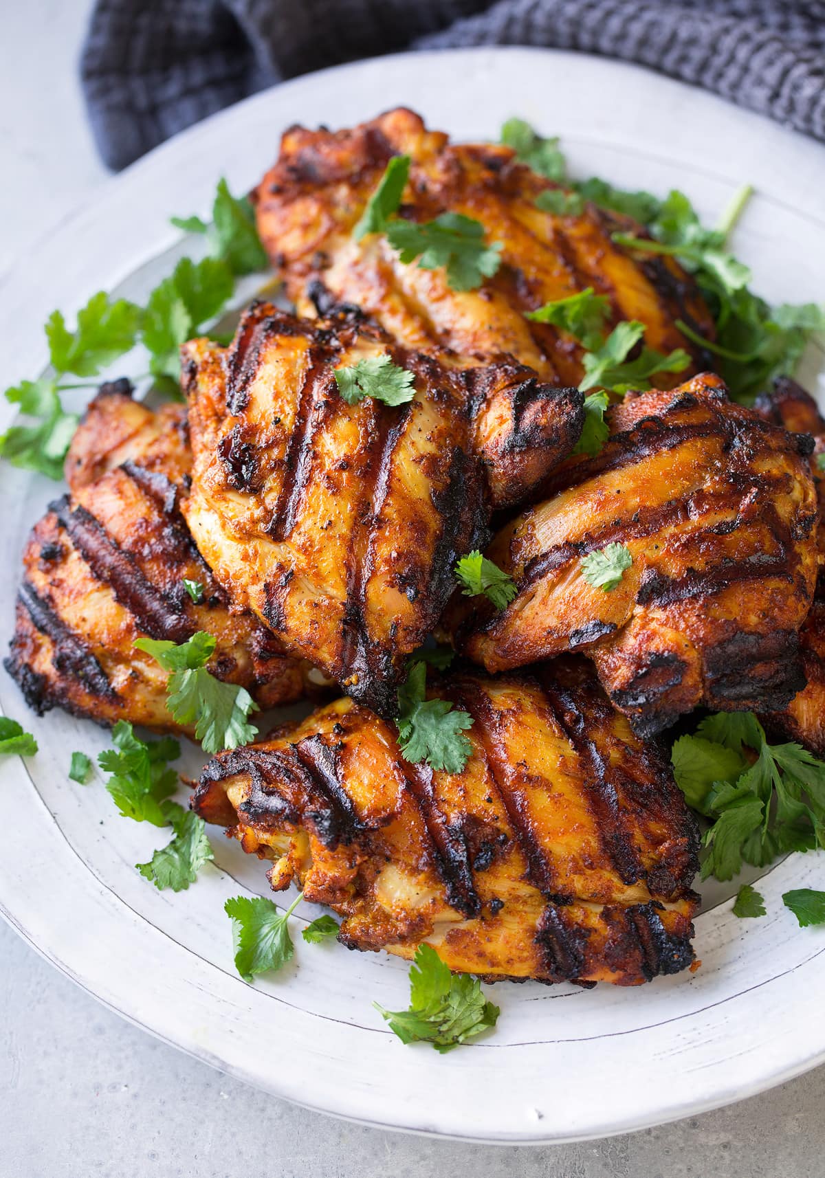 Tandoori Chicken Platter full of Tandoori Chicken pieces garnished with cilantro.