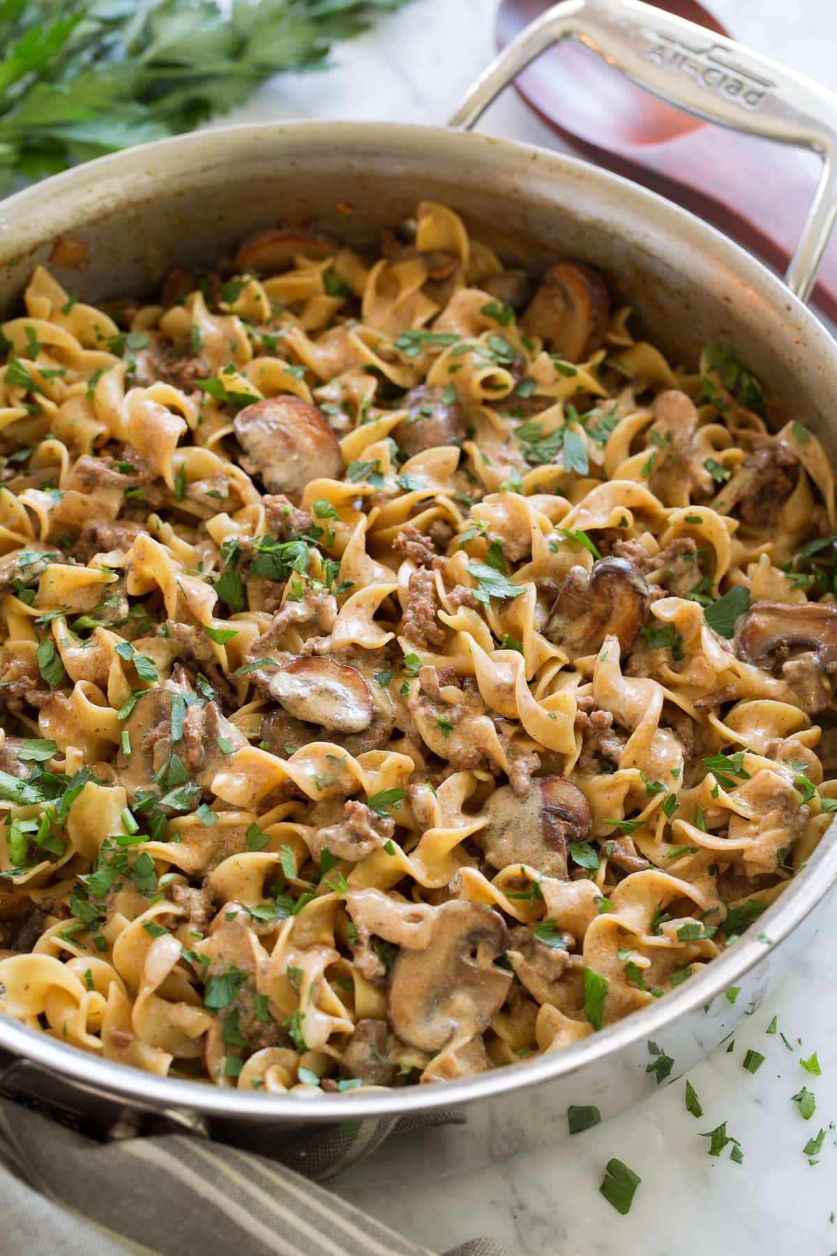 Beef Stroganoff Beef Stroganoff Recipe in a large stainless steel saute pan set over a marble surface.