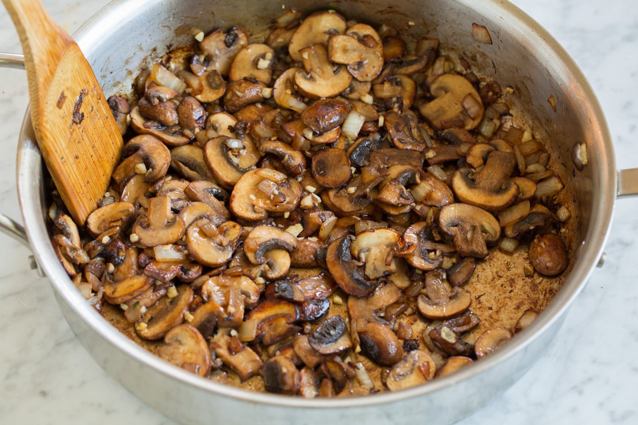 Beef Stroganoff Sauteeing mushrooms and onions in a saute pan for beef stroganoff