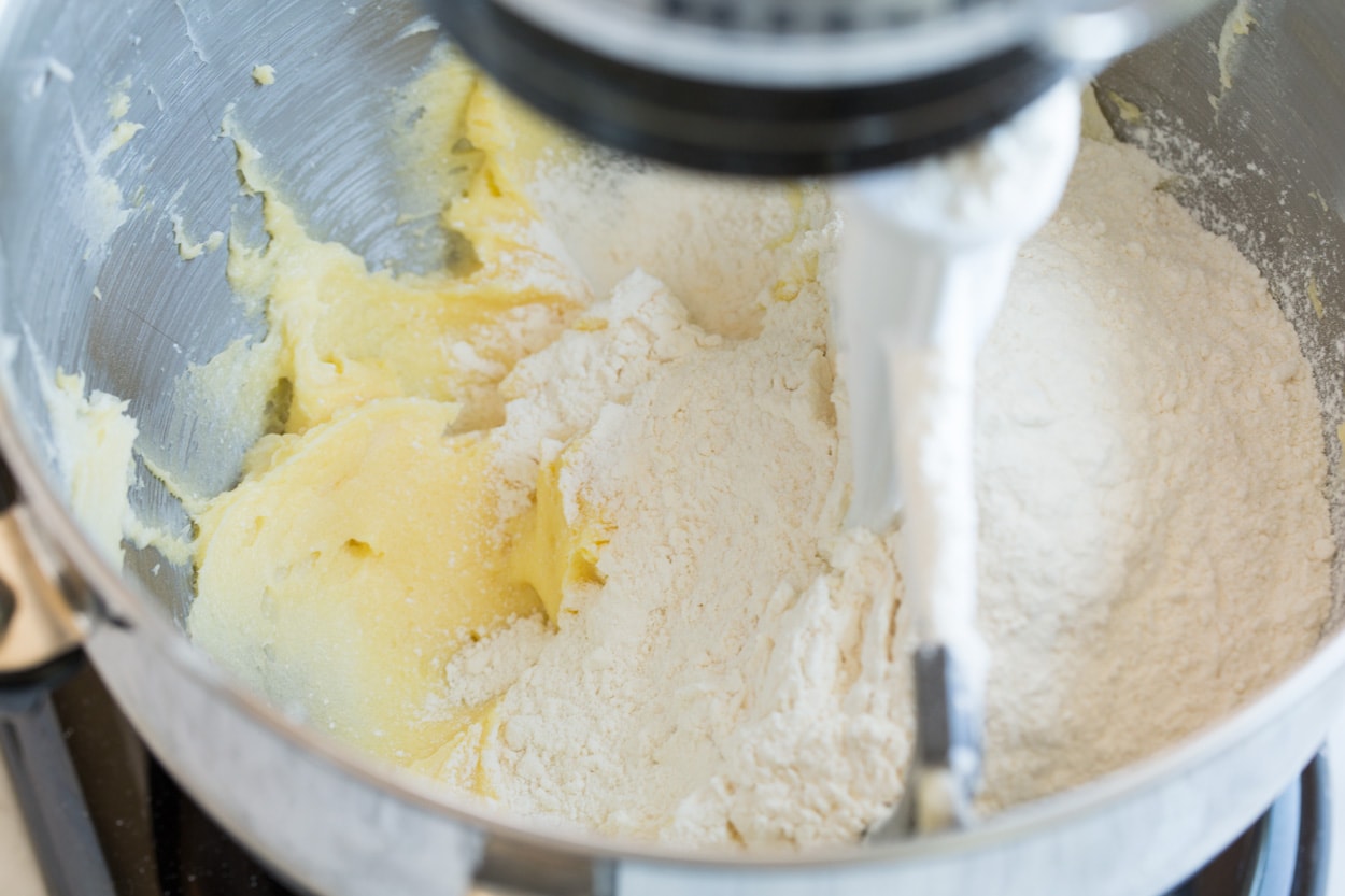 Butter Cookies Adding flour to butter cookie mixture in stand mixer.