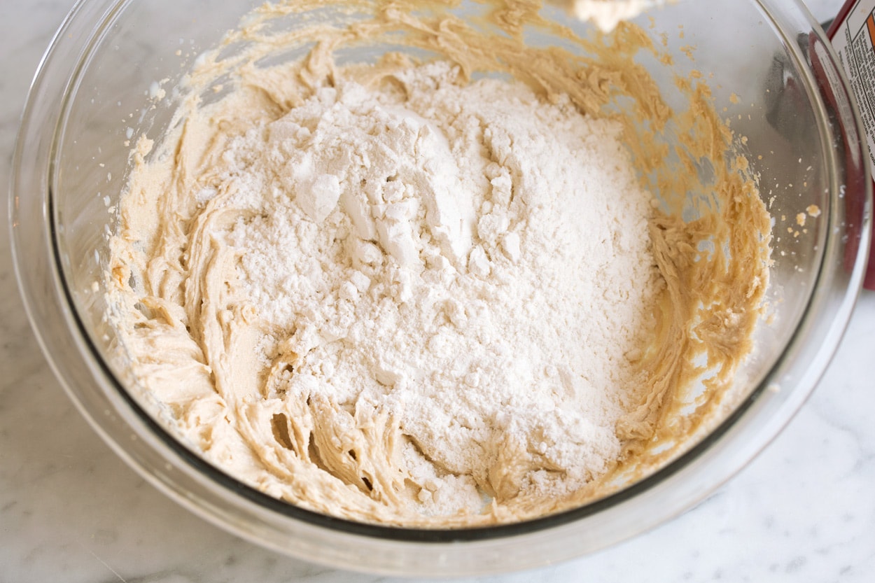 https://active-metabolism.news/edible-cookie-dough/ Adding flour to mixing bowl for edible cookie dough
