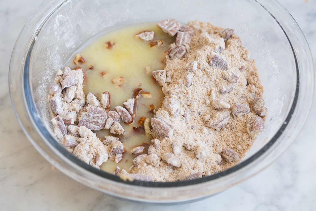 Sweet Potato Casserole Adding butter to topping mixture in glass bowl, for sweet potato casserole.