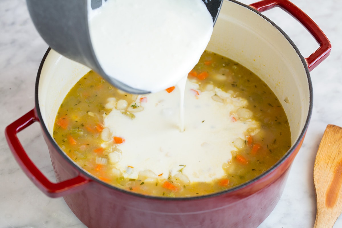 Creamy Chicken Gnocchi Soup Adding thickened milk mixture into pot.