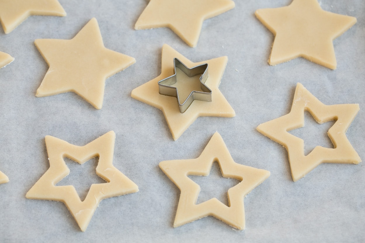 Stained Glass Cookies Cutting center portion from cookies with a small star cookie cutter.
