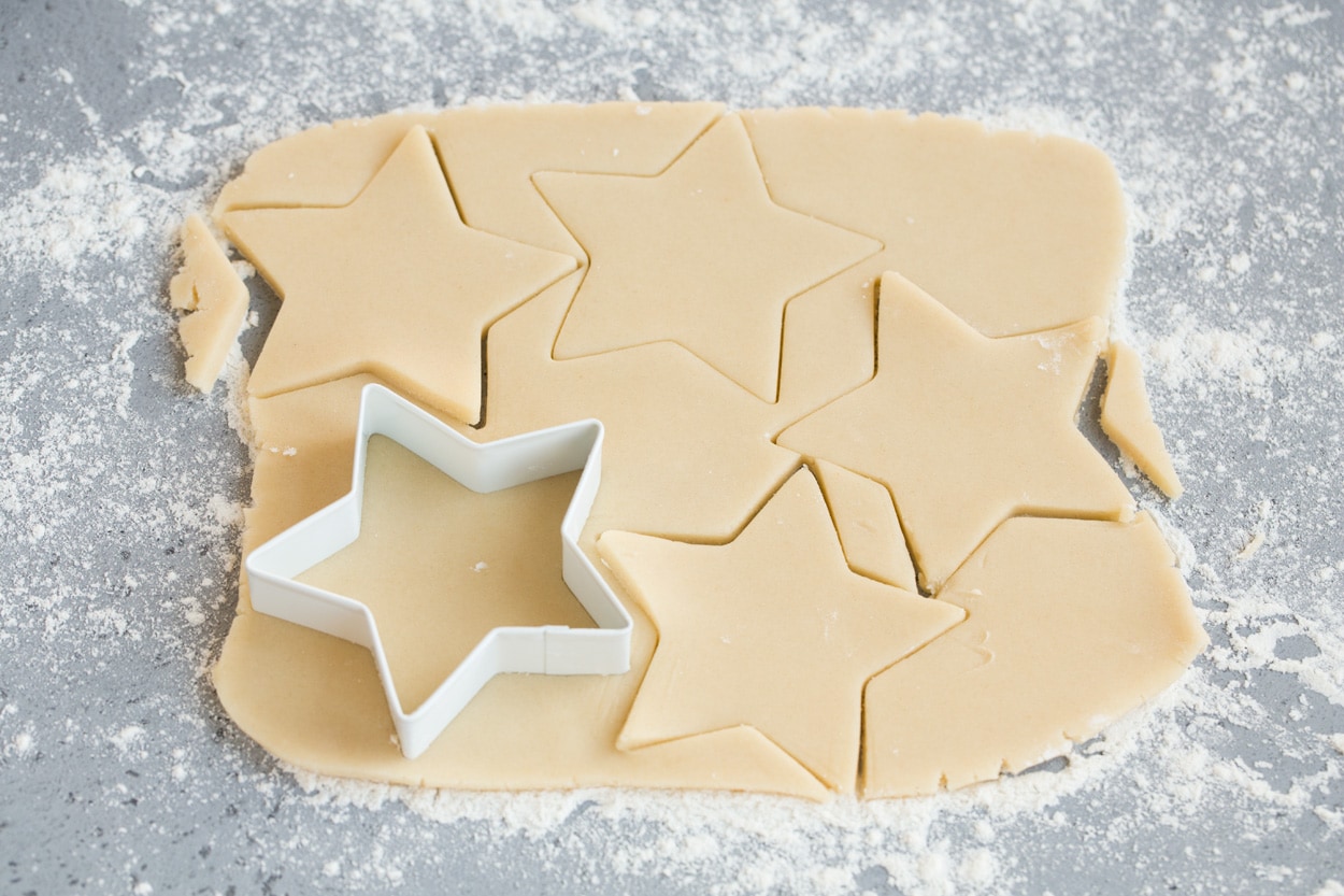Stained Glass Cookies Cutting star shapes from cookie dough for stained glass cookies.