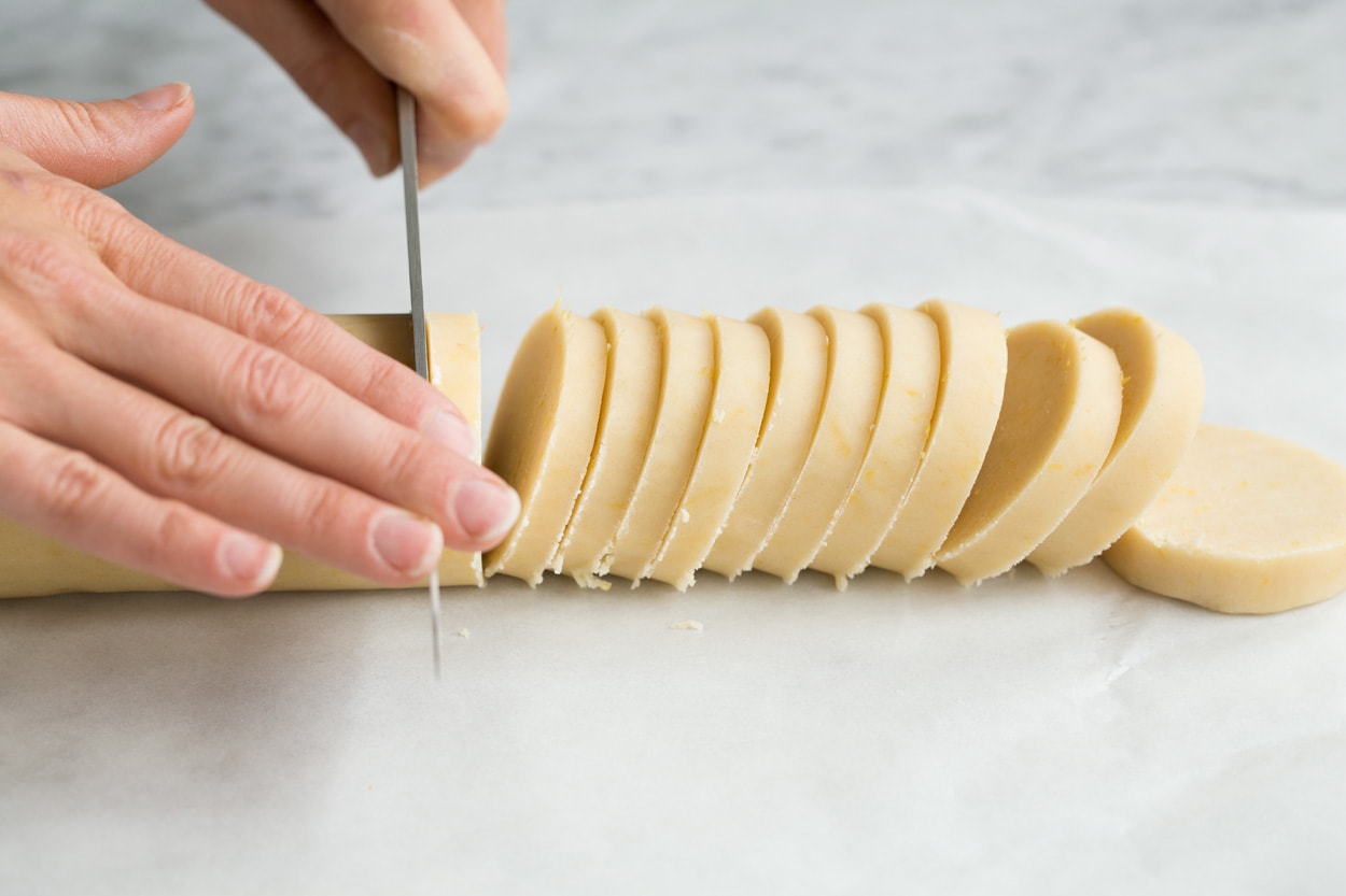 Lemon Shortbread Showing how to make lemon shortbread cookies. Cutting log into slices.