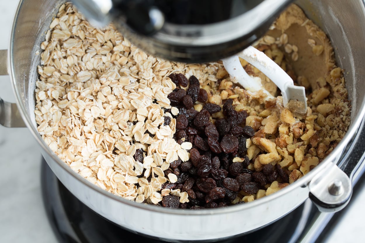 BEST Oatmeal Cookies! Adding oatmeal, raisins, walnuts to stand mixer to make oatmeal raisin cookies.