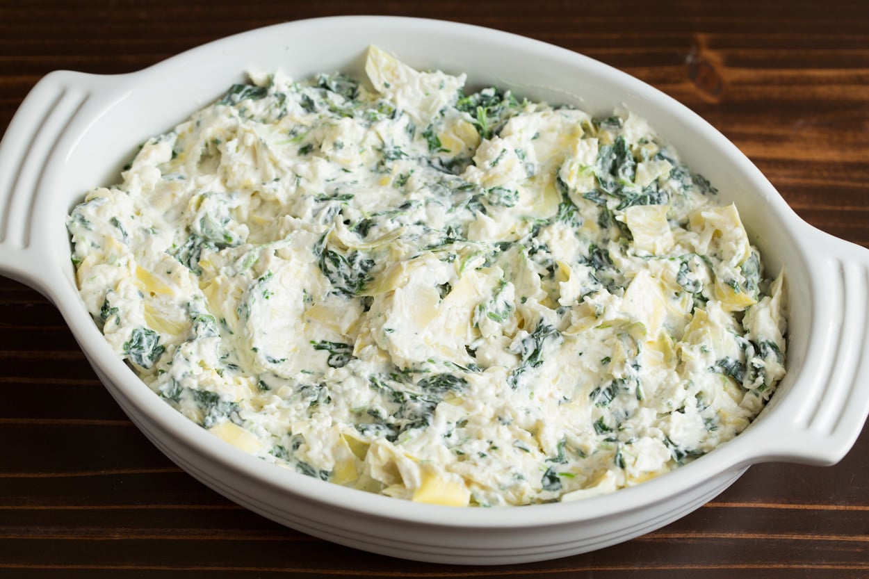 Spinach Artichoke Dip Spreading Spinach Artichoke Dip mixture into small casserole dish.