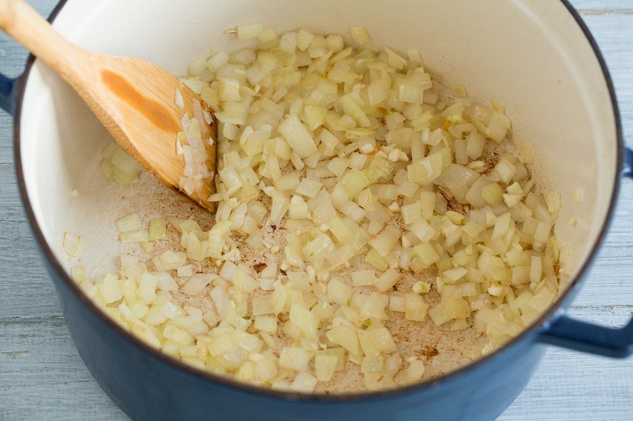 White Chicken Chili Showing how to make white chicken chili. Sauteing onion in oil in a large cast iron pot.