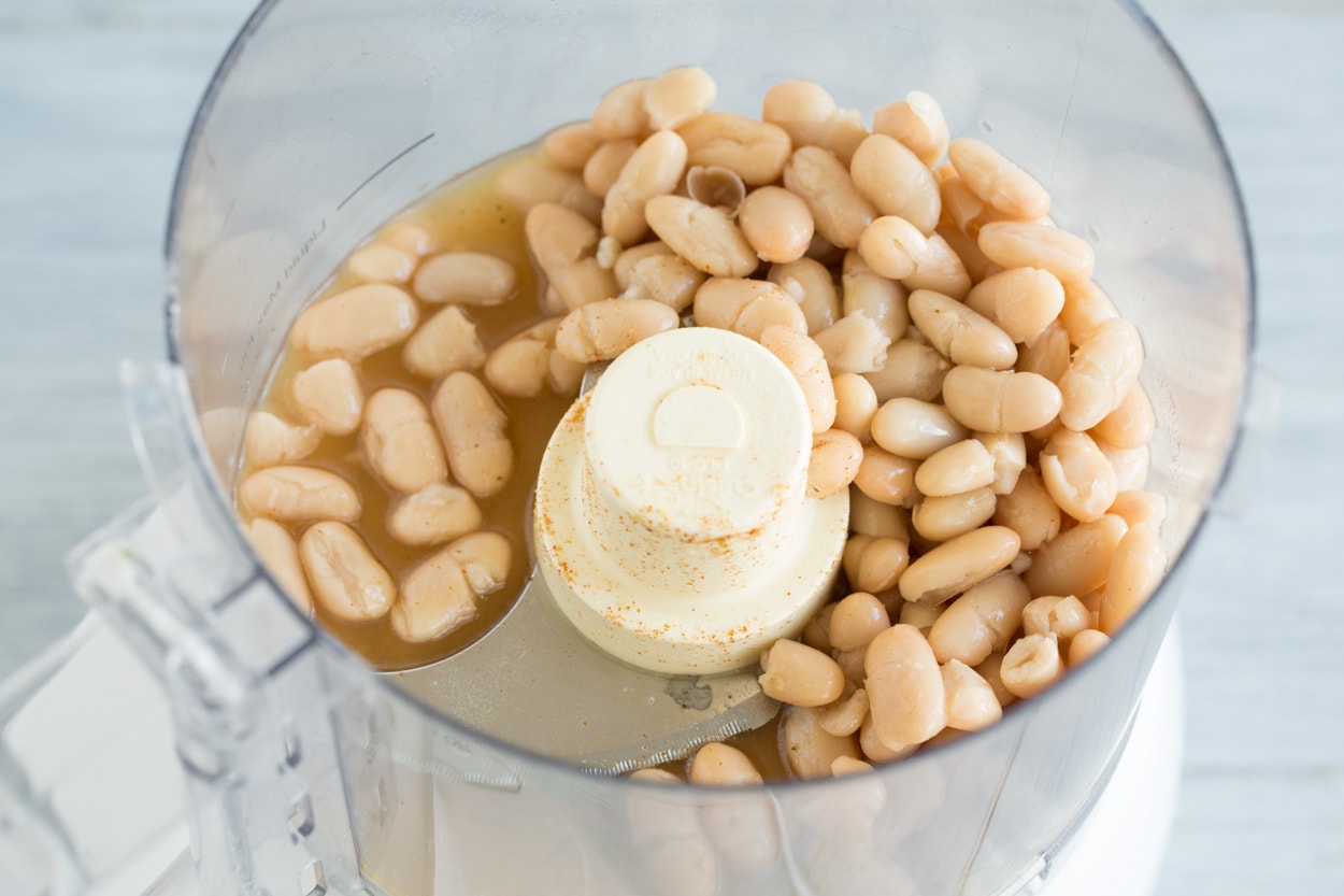 White Chicken Chili Pureeing cannellini beans in food processor for white chicken chili.