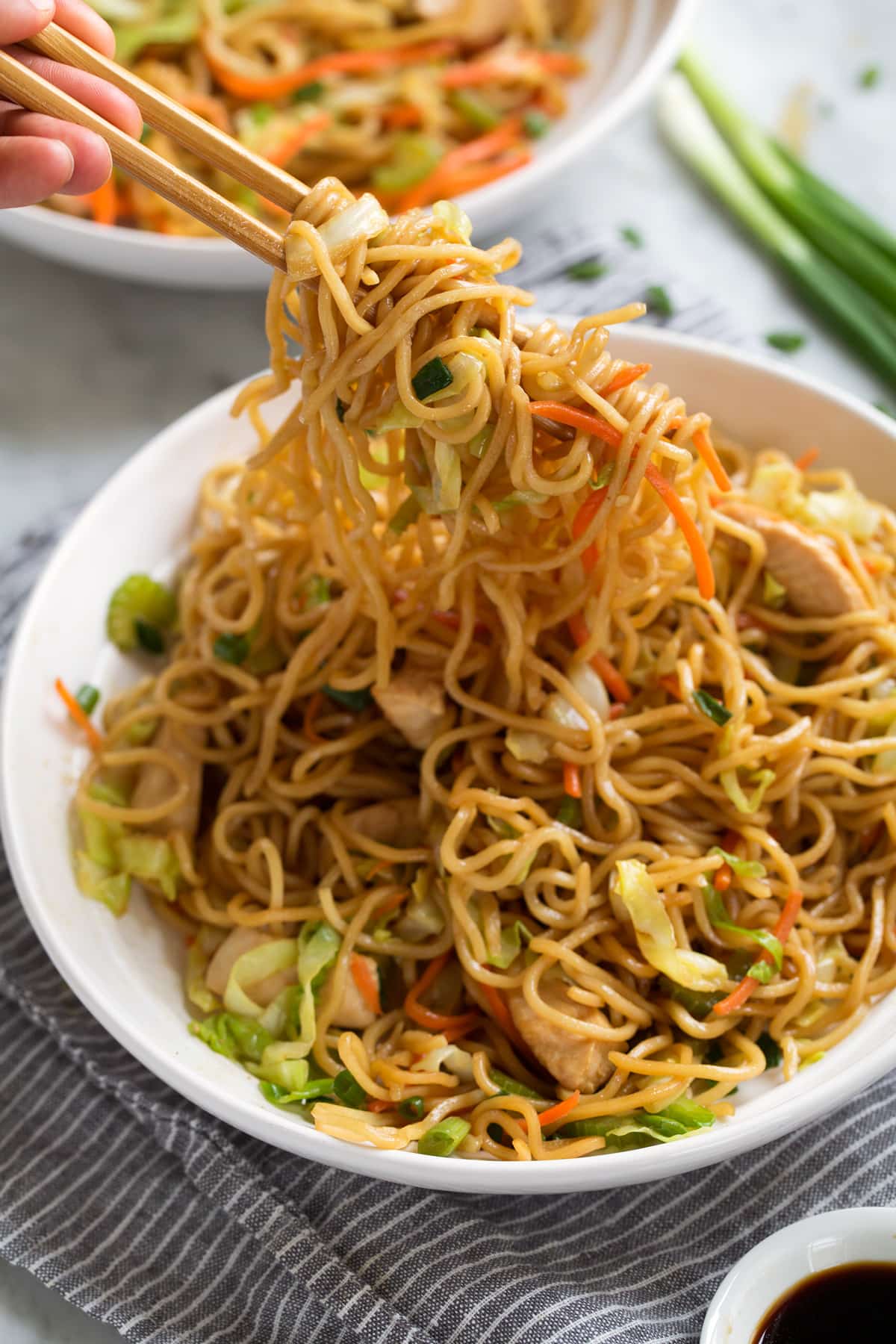 Chicken Chow Mein Recipe Scooping chow mein with chop sticks.
