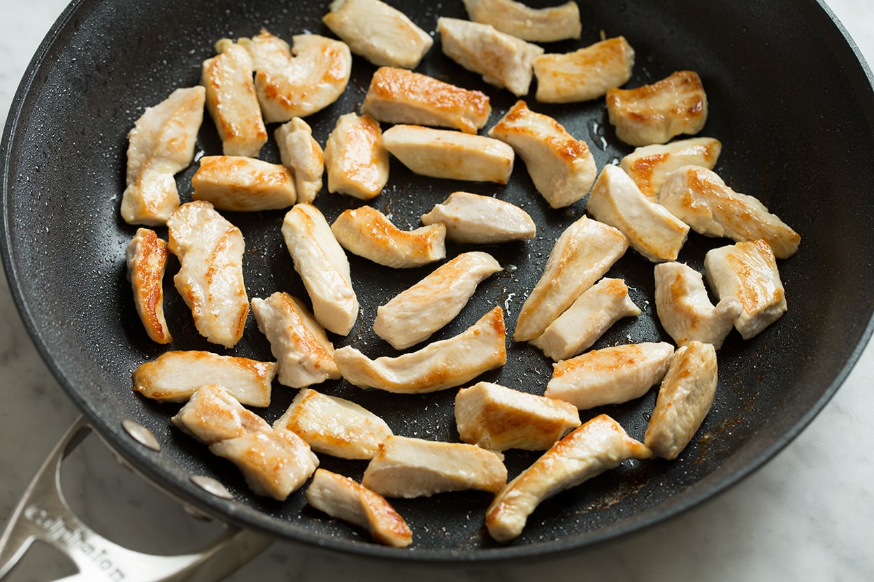 Chow Mein Searing pieces chicken in skillet for chow mein.