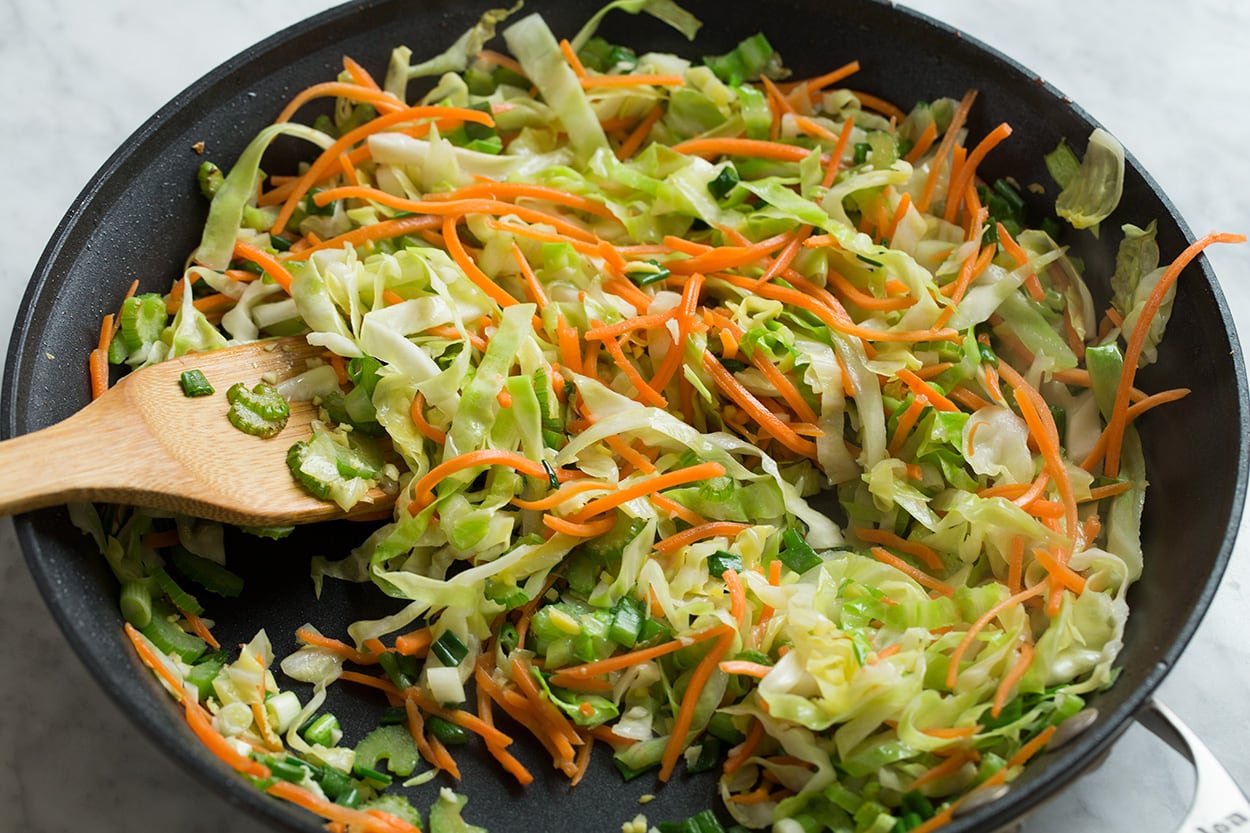 Chicken Chow Mein Sauteeing vegetables in a skillet for chow mein.