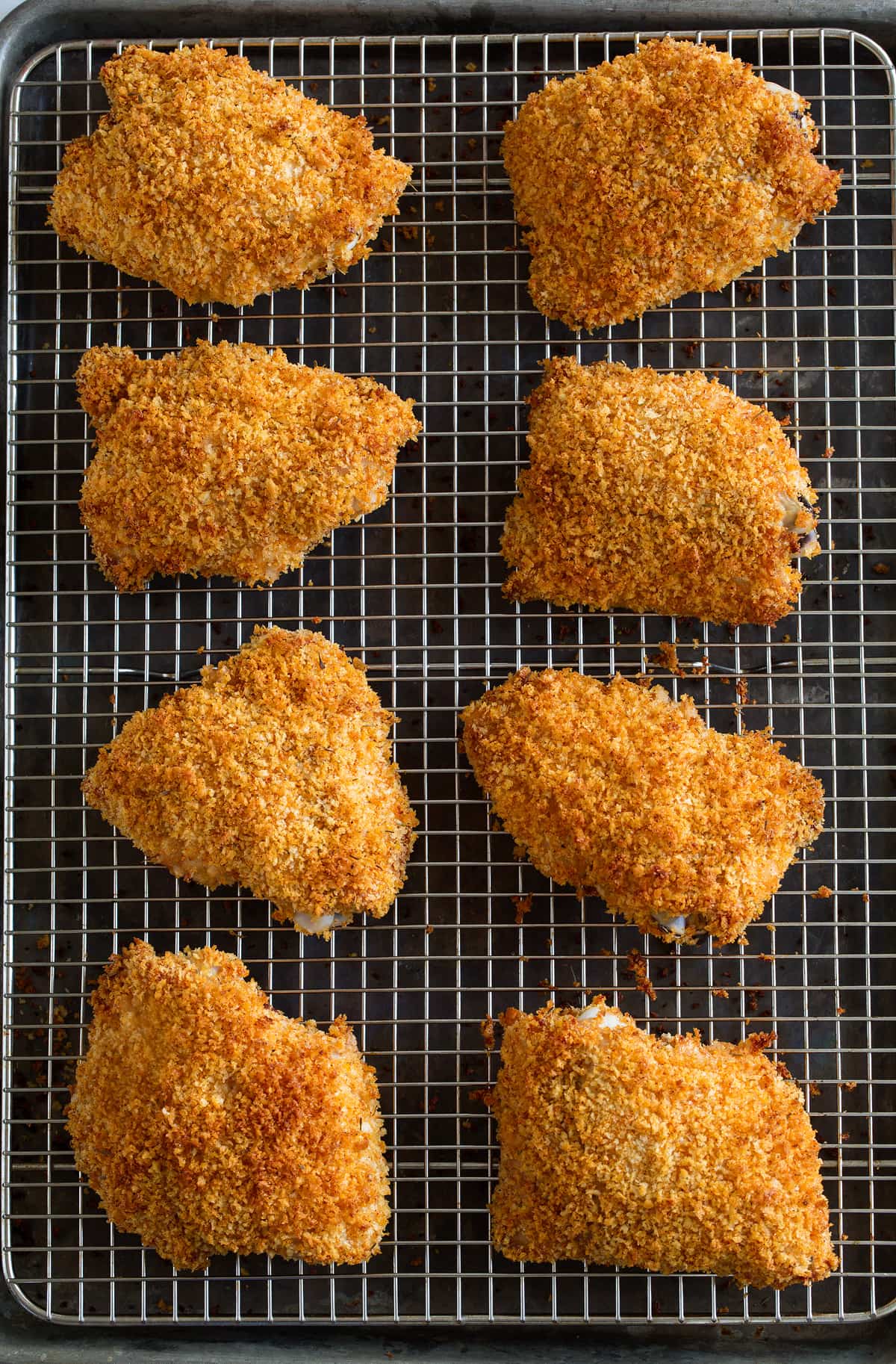 Oven Fried Chicken Oven Fried Chicken on a cooling rack set over a baking sheet.