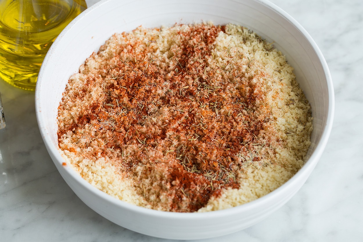 Oven Fried Chicken Mixing panko with olive oil and spices in a shallow dish for oven fried chicken.