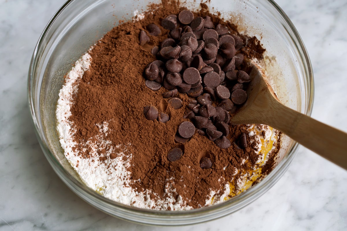 Best Cocoa Brownies Adding flour, cocoa powder and chocolate chips to mixing bowl for brownies.