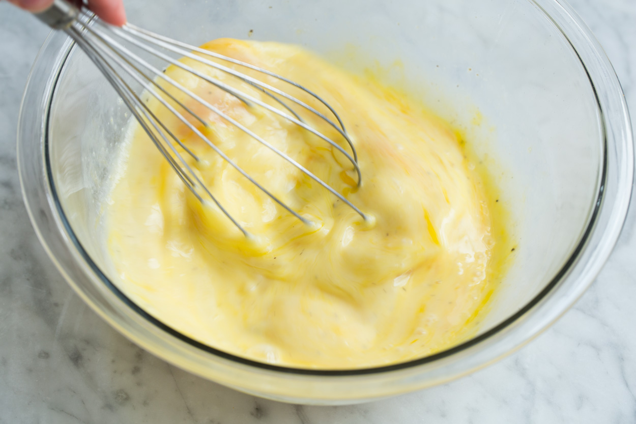 Frittata Recipe (Bacon, Spinach, Tomato and Swiss) Whisking egg mixture in glass mixing bowl.