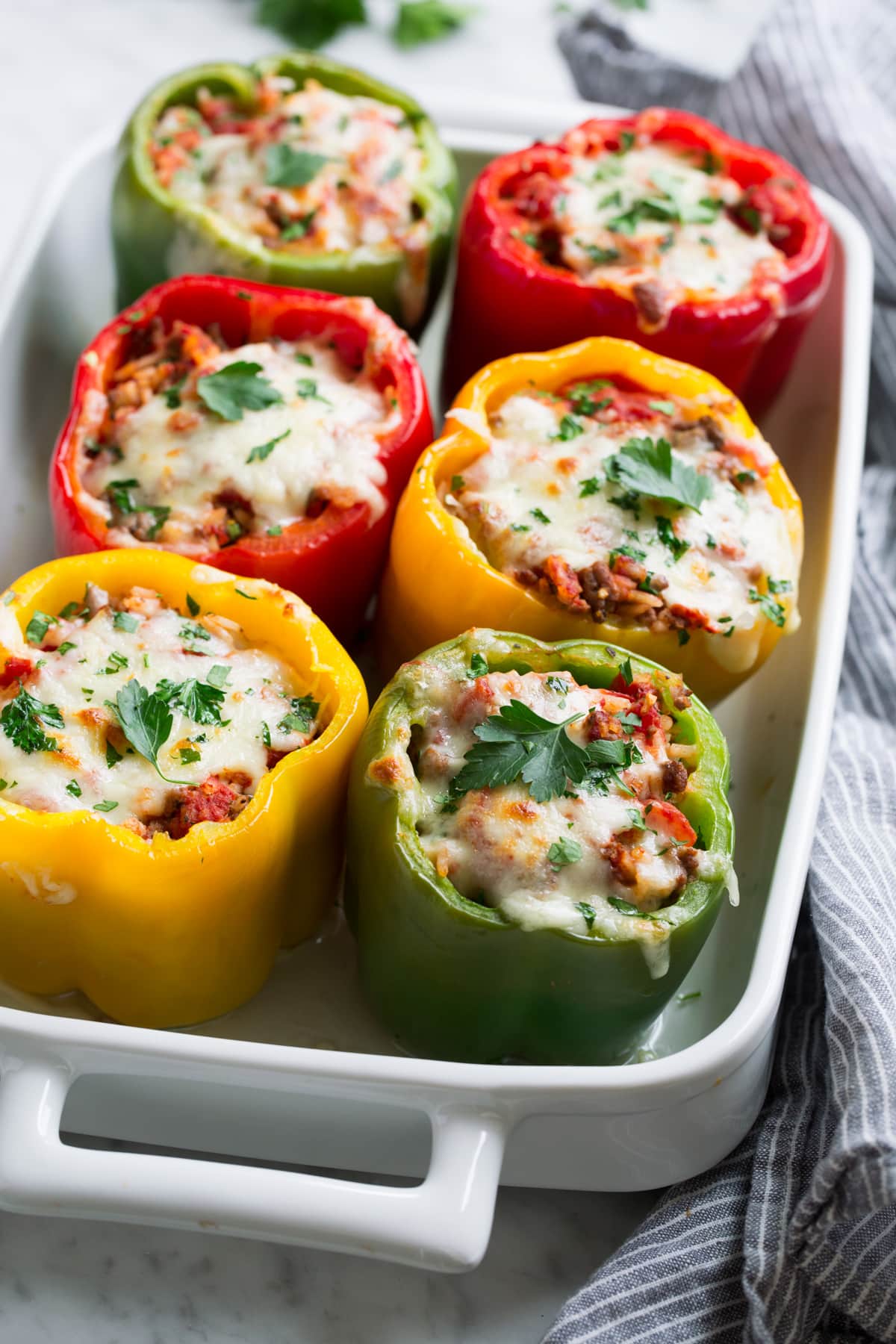 Stuffed Peppers Multi-color stuffed peppers in a white baking dish.