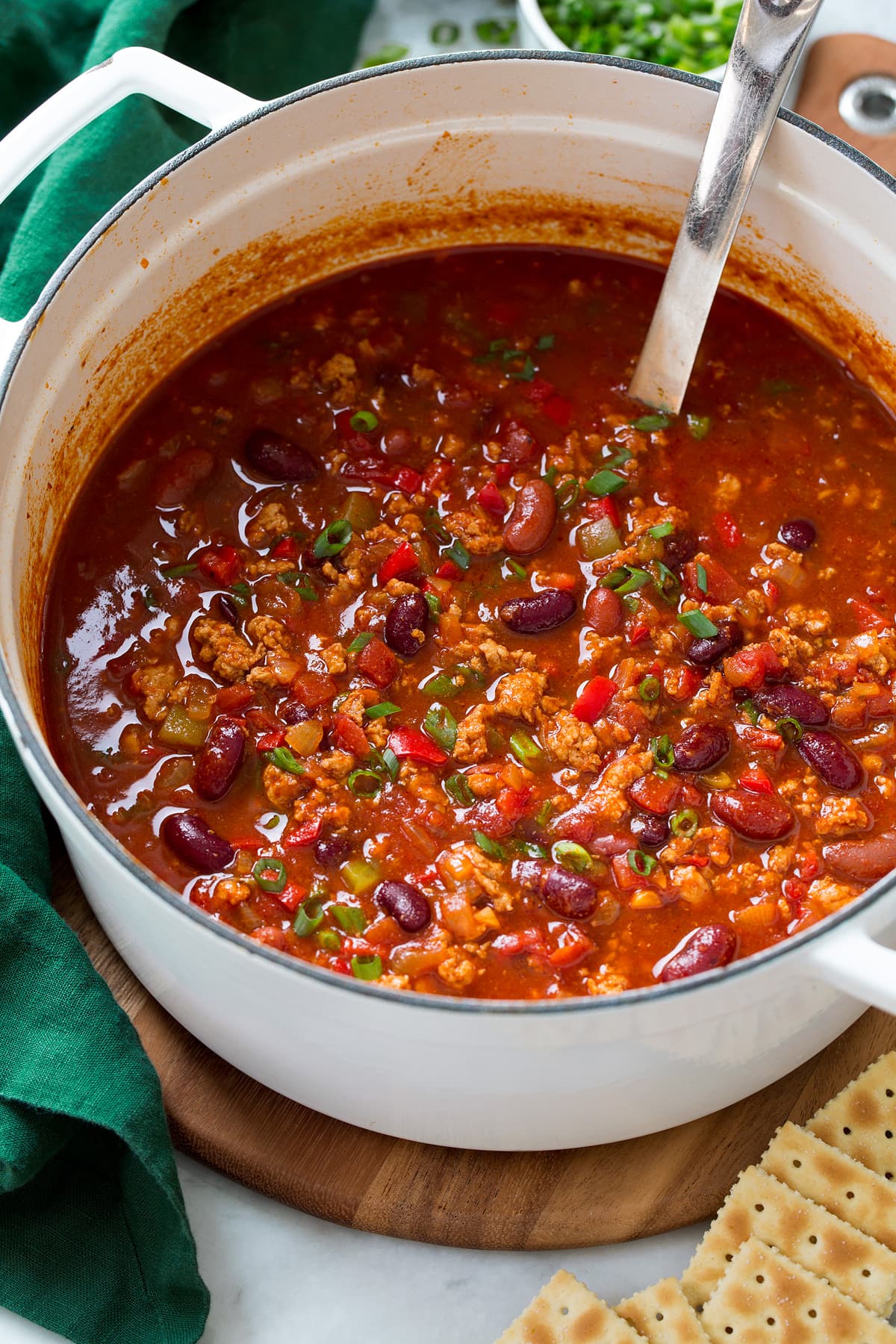 Turkey Chili A white pot filled with turkey chili.