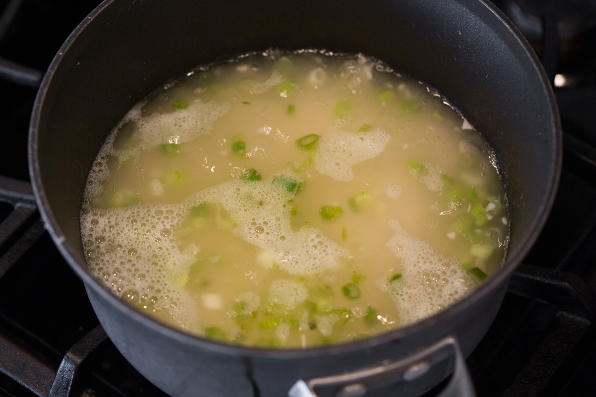 Cilantro Lime Rice Boiling water in saucepan with rice and flavorings.
