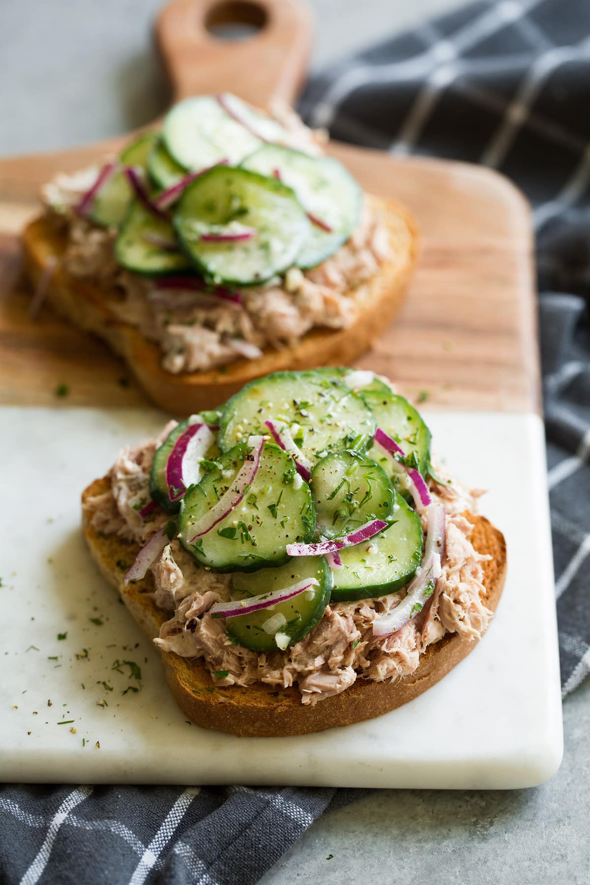 Refreshing Cucumber Salad Cucumber salad served on top of an open faced tuna salad sandwich. Served with a side of potato chips. This is a serving suggestion.