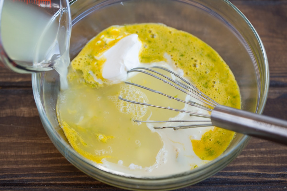 BEST EVER Key Lime Pie recipe! Adding lime juice and sweetened condensed milk to key lime pie filling mixture.