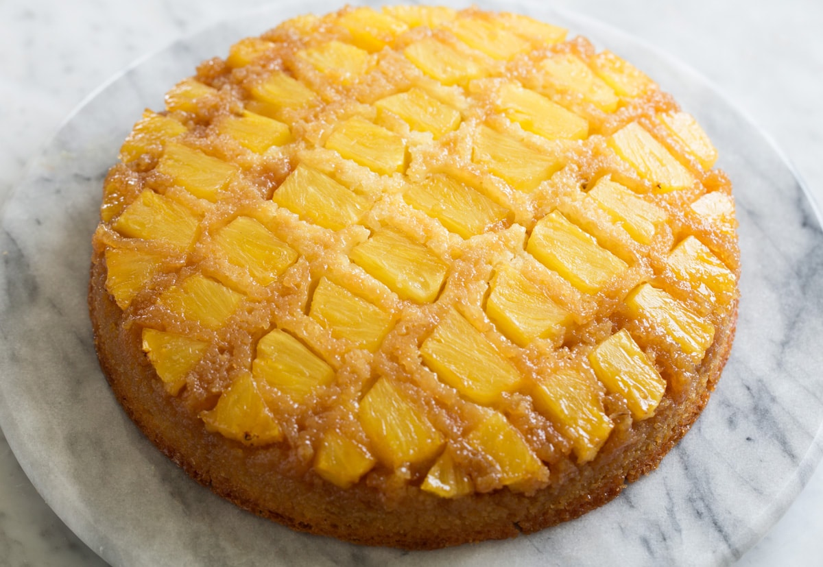 Pineapple Upside Down Cake Whole Pineapple Upside Down Cake shown after baking and inverting onto marble platter.