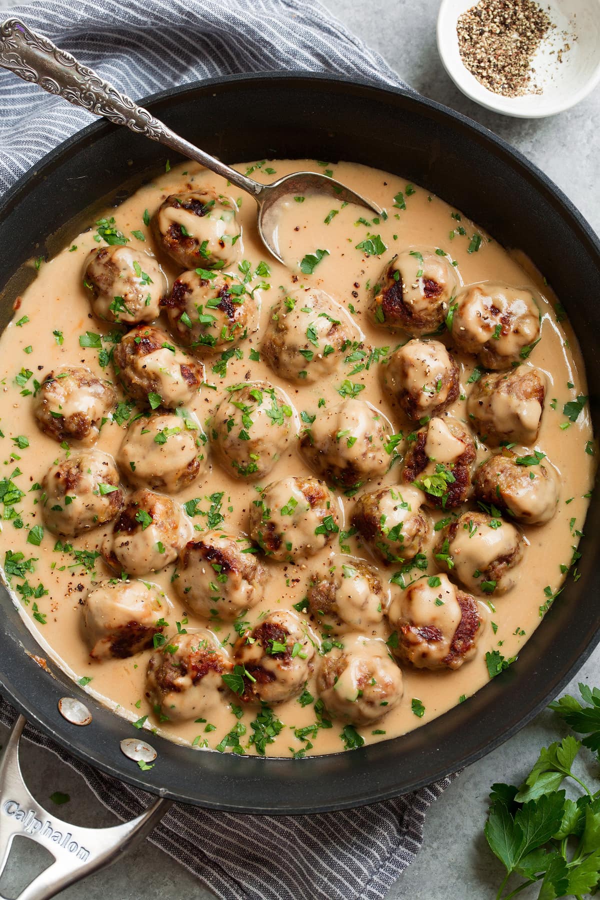 Best Swedish Meatballs (Oven Baked)! Baked Swedish meatballs in a skillet after tossing with sauce.