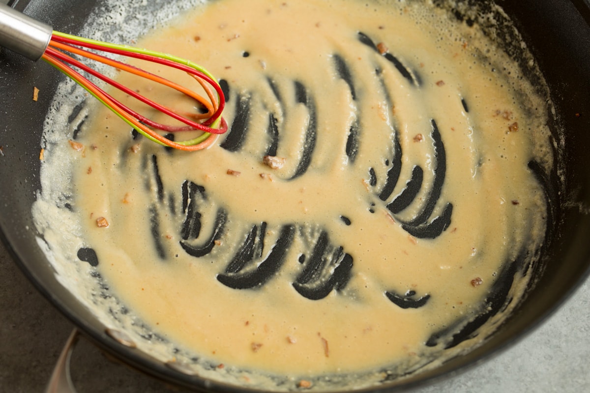 BEST Swedish Meatballs Recipe (Oven Baked)! Making a roux with butter and flour in skillet for Swedish meatball sauce.
