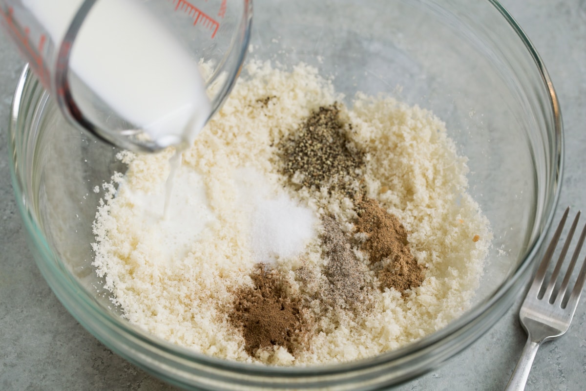 BEST Swedish Meatballs Recipe (Oven Baked)! Showing how to make Swedish meatballs. Mixing fresh breadcrumbs with spices and milk.