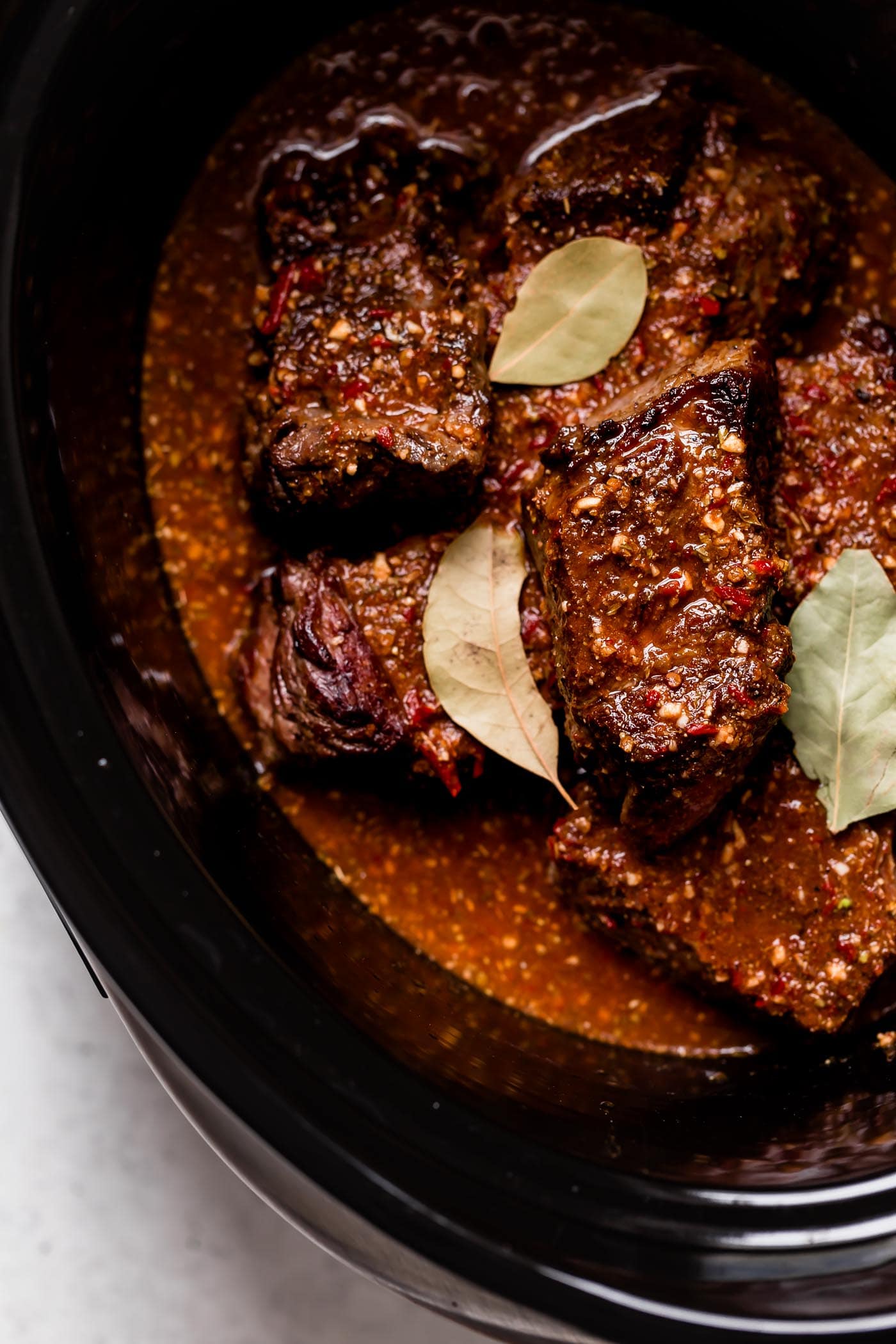 Slow Cooker Barbacoa Beef Barbacoa beef in slow cooker shown in chunks after cooking.