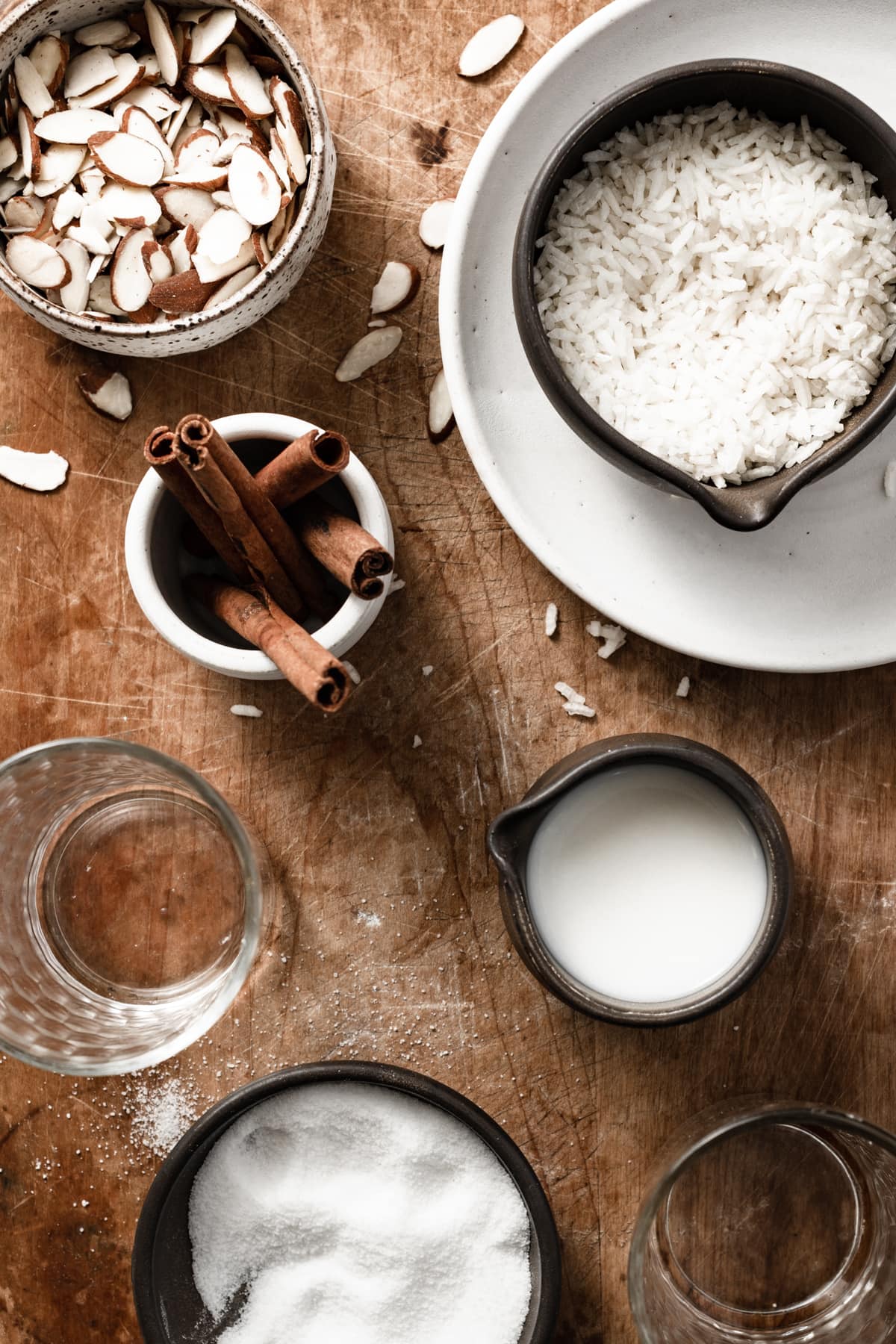 Horchata Horchata ingredients shown here including rice, almonds, cinnamon, stick, water, milk, and sugar.