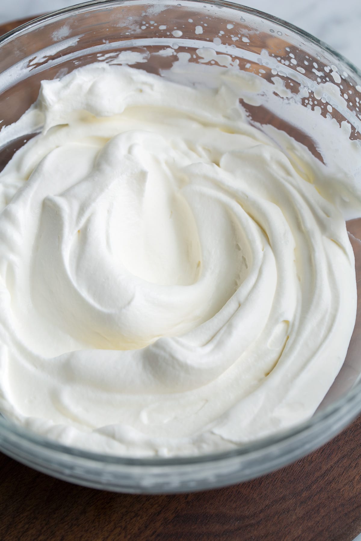 Whipped Cream Homemade whipped cream in a glass mixing bowl