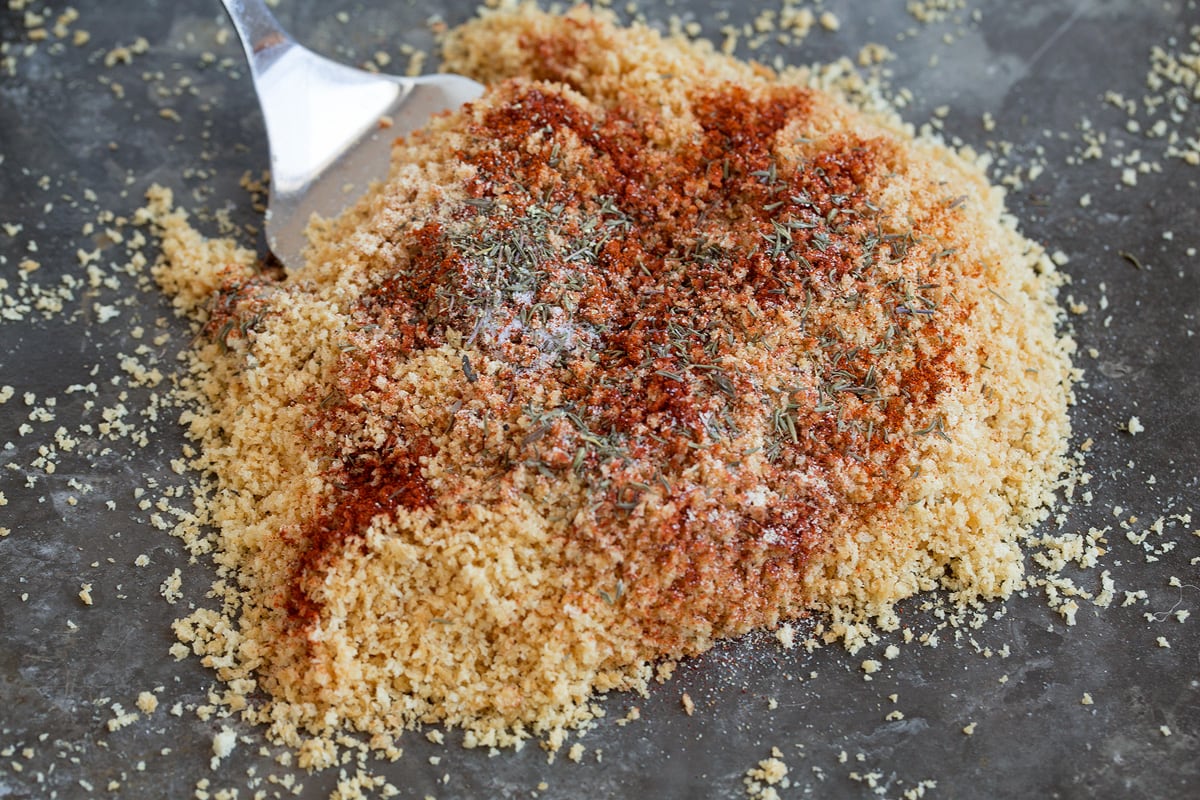 Baked Chicken Nuggets Tossing panko breadcrumbs with seasonings.