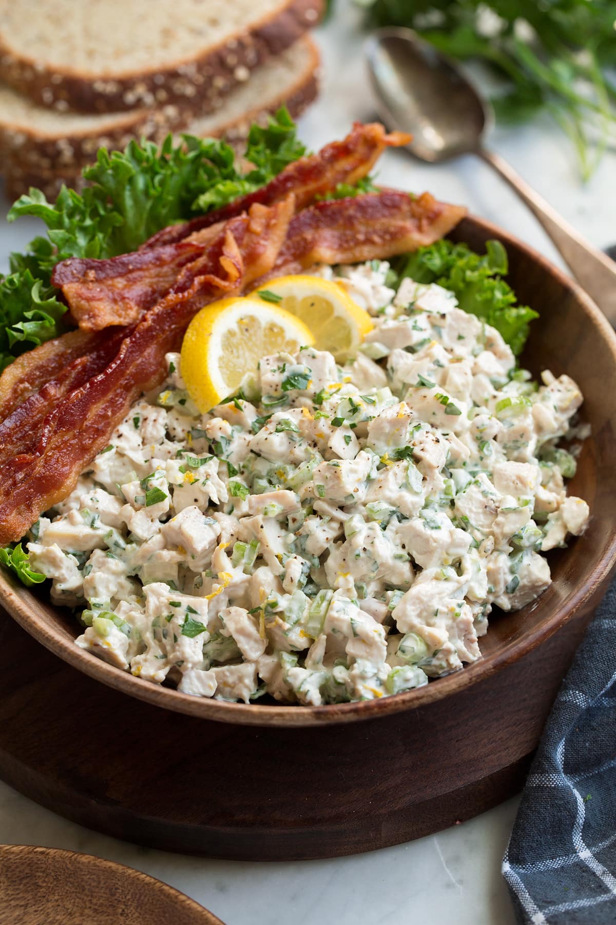 The Best Chicken Salad! Chicken salad in a wooden serving bowl set over a marble surface.