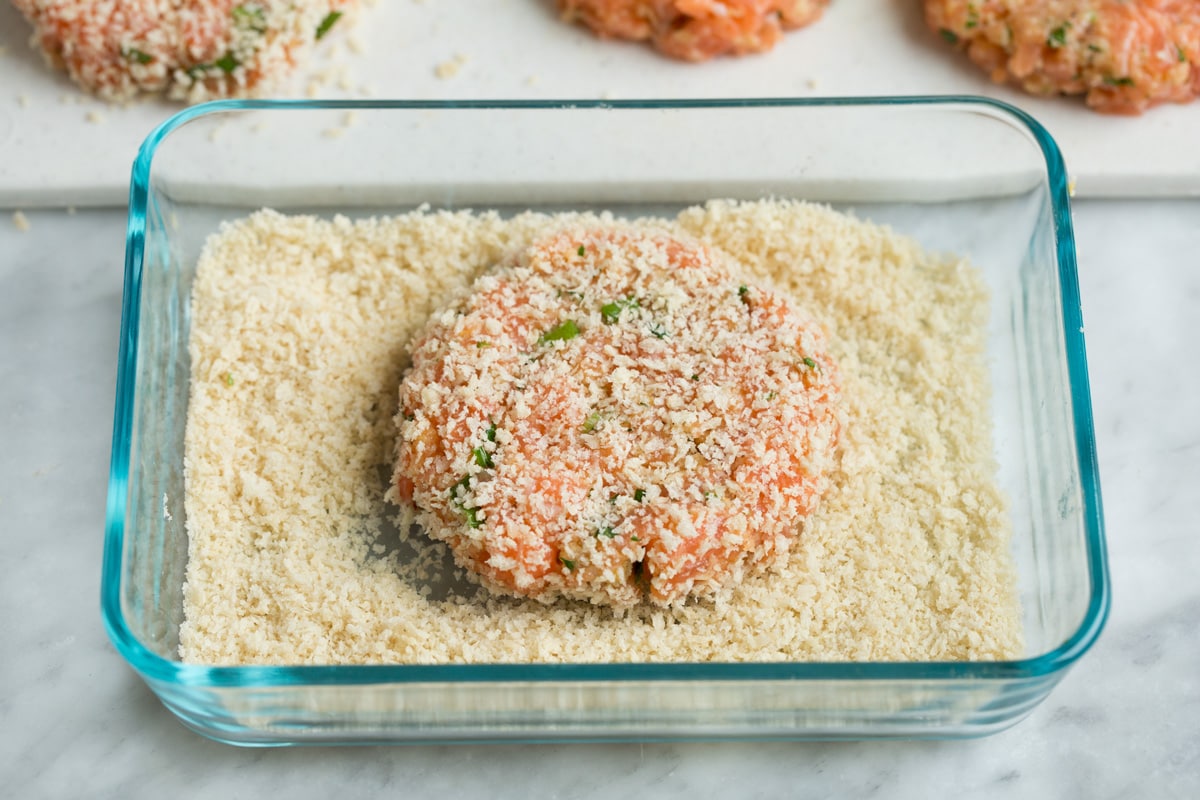 Crispy Salmon Patties (made with fresh salmon, not canned!) Salmon patty dredged in panko in a small rectangular glass dish.