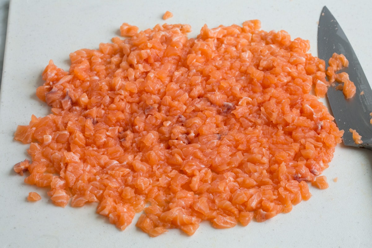 Crispy Salmon Patties (made with fresh salmon, not canned!) Finely diced salmon on a cutting board.