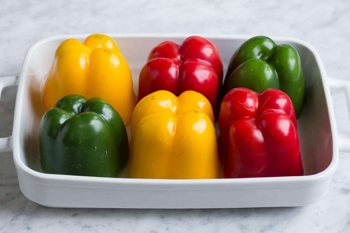 Stuffed Peppers 6 multicolor bell peppers in a white baking dish.