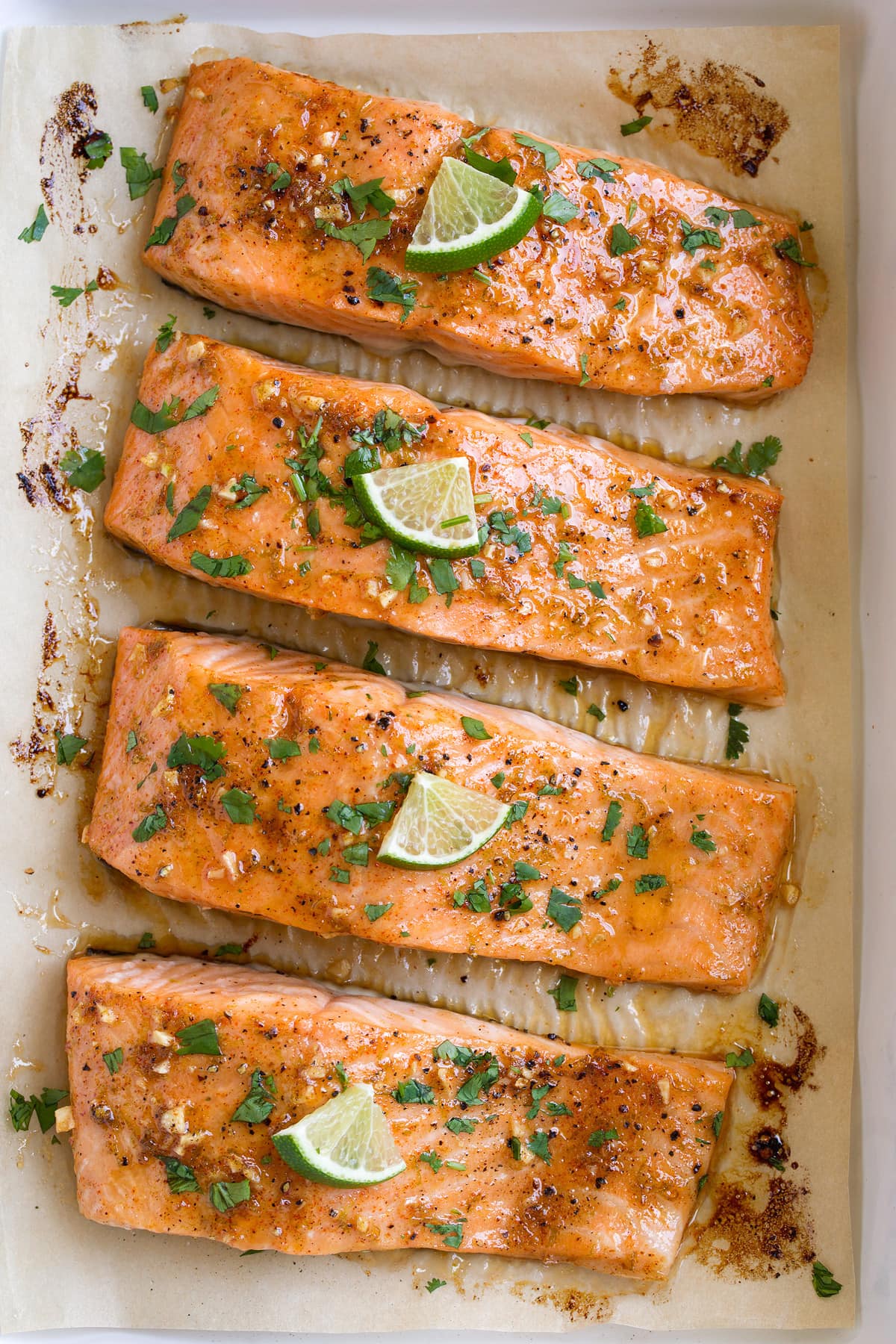 Brown Sugar Lime Baked Salmon Close up overhead image of row of oven baked salmon fillets.