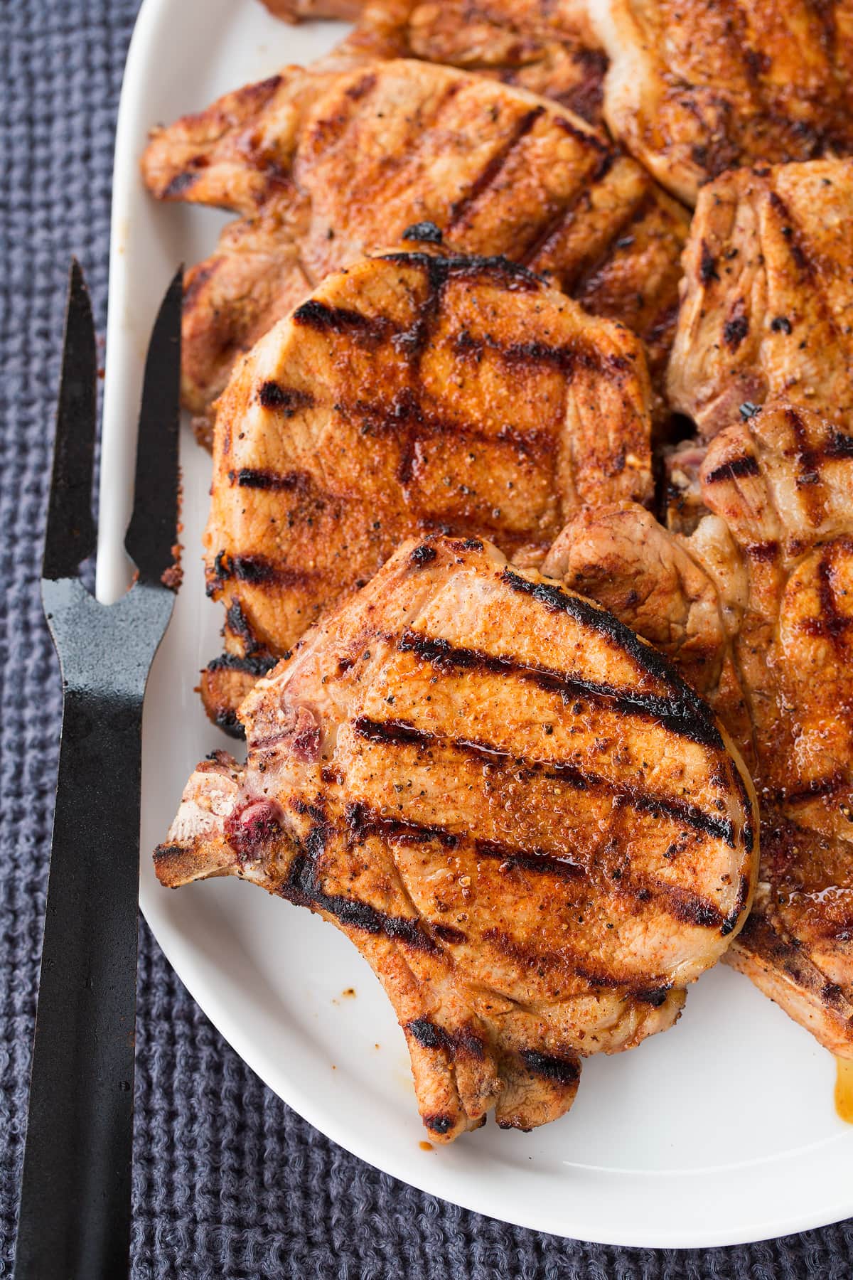 Grilled Pork Chops Grilled pork chops on a white oval platter.