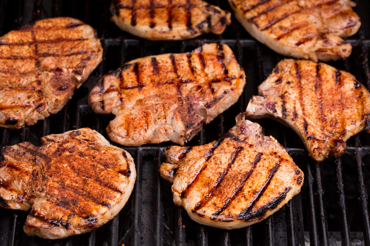 Grilled Pork Chops pork chops on a grill shown after finished cooking