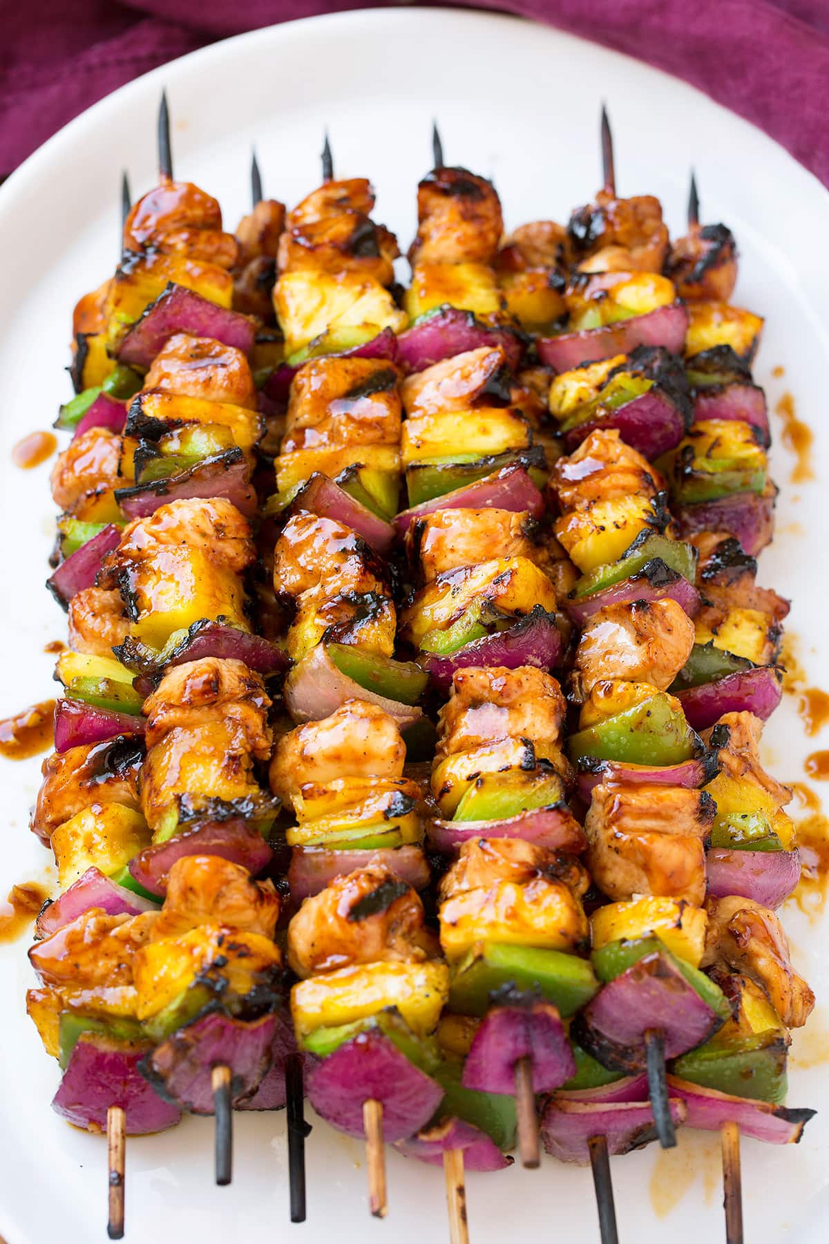 Hawaiian Chicken Kebabs Grilled Hawaiian Chicken Kebabs on a white platter.