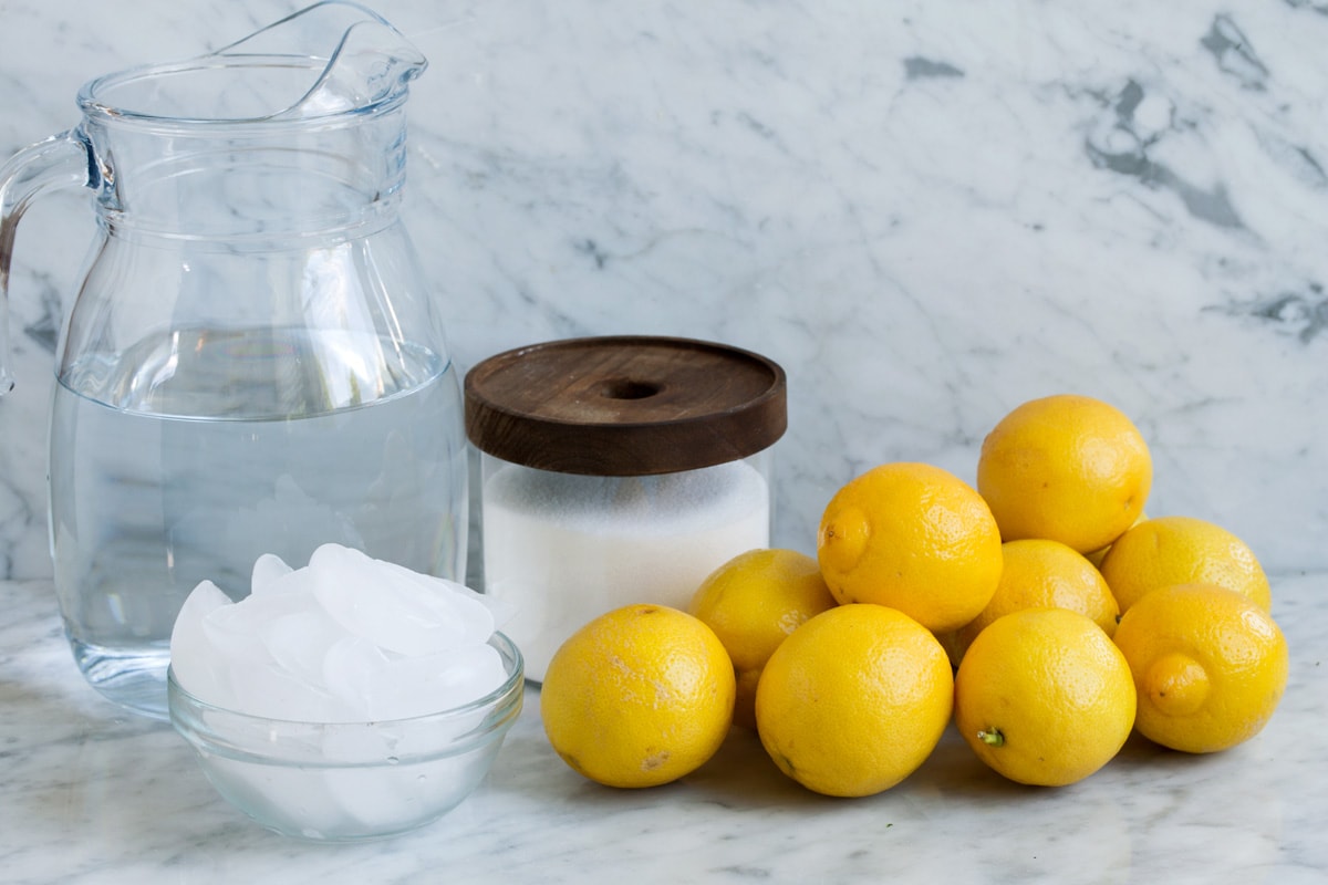 Lemonade Ingredients to make lemonade, including fresh lemons, sugar, ice and water.
