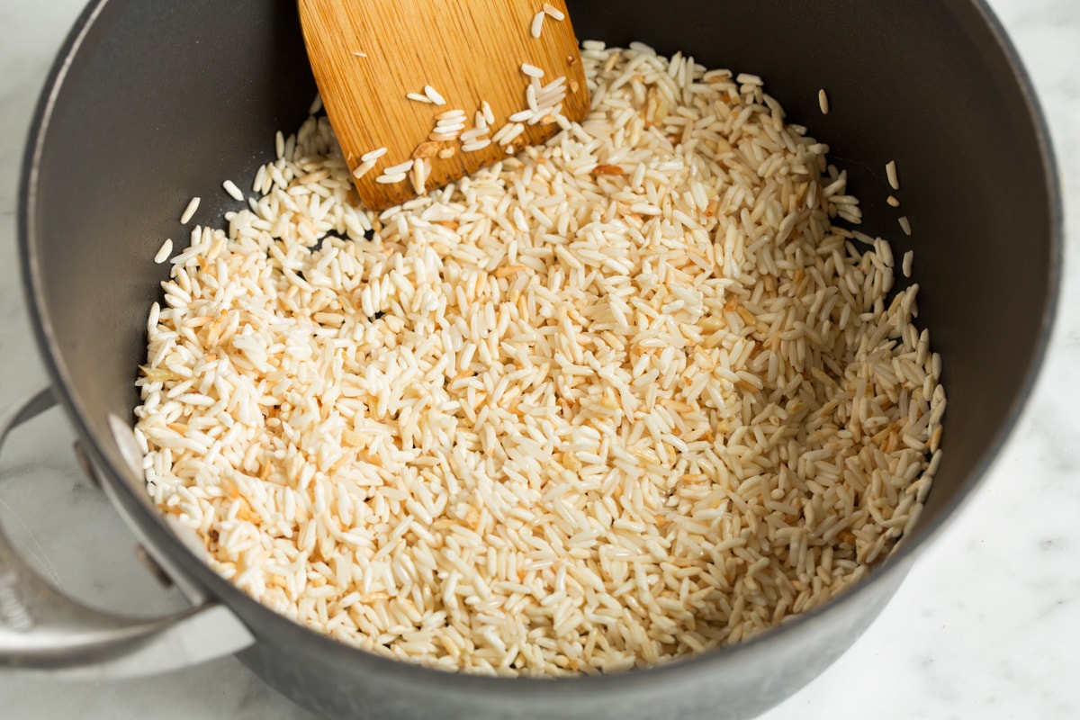 Mexican Rice Sautéing rice in a saucepan.
