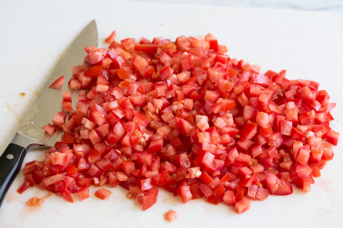 Fresh Bruschetta Chopped roma tomatoes on a cutting board