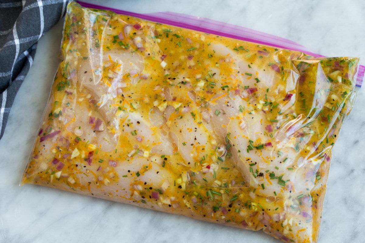 Triple Citrus Chicken Marinade - perfectly bright and refreshing! Total upgrade to plan chicken breasts or thighs. Such a delicious summer recipe! #chicken #marinade #recipe #dinner #grilled Chicken breasts in marinade in a resealable bag.
