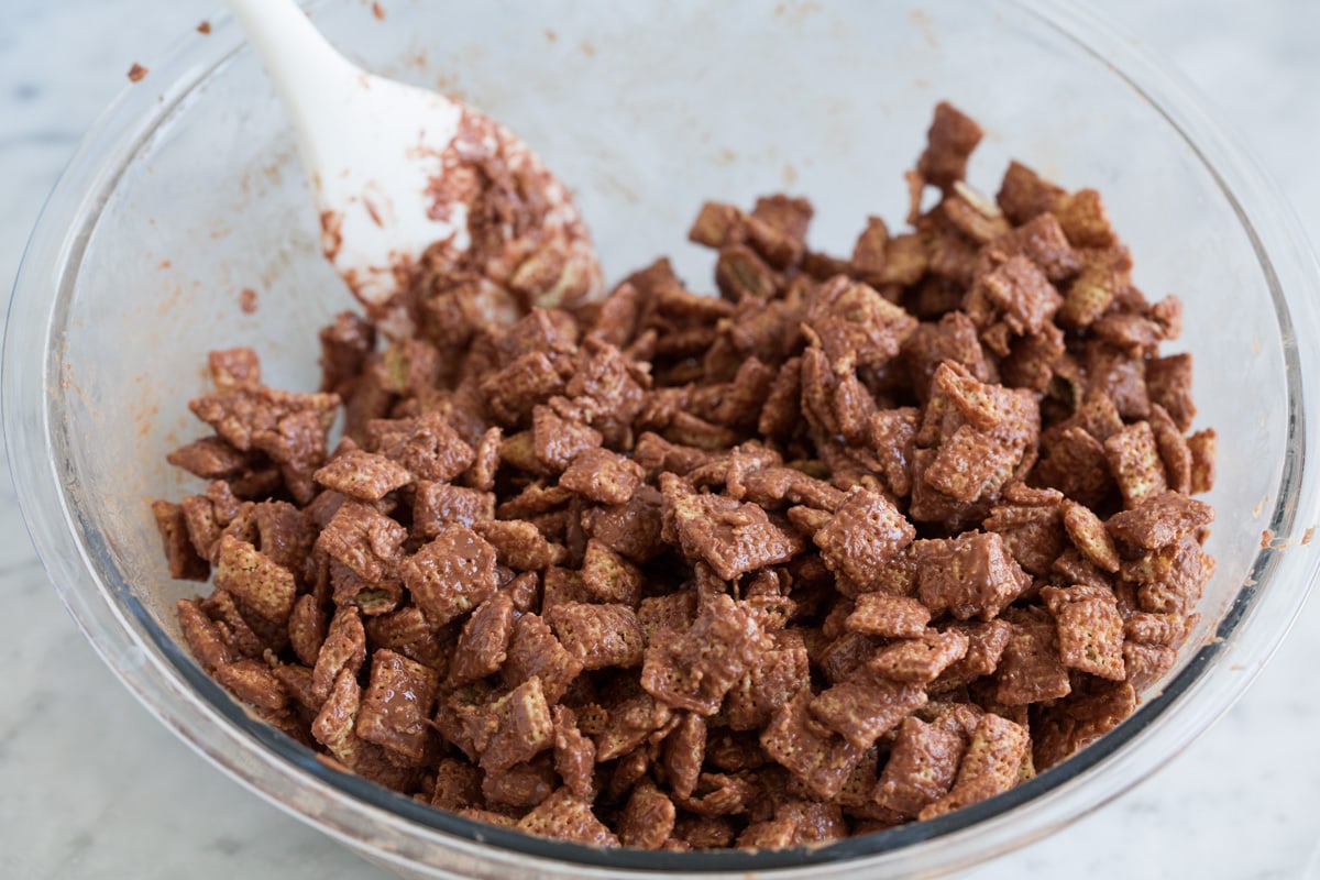 Perfect Puppy Chow {Muddy Buddies}! - one of my go-to treats! These are dangerously addictive! Perfect for parties, holidays and traveling too. #muddybuddies #puppychow #treat #chocolate #chex #peanutbutter Crispy rice cereal coated with melted chocolate peanut butter mixture.