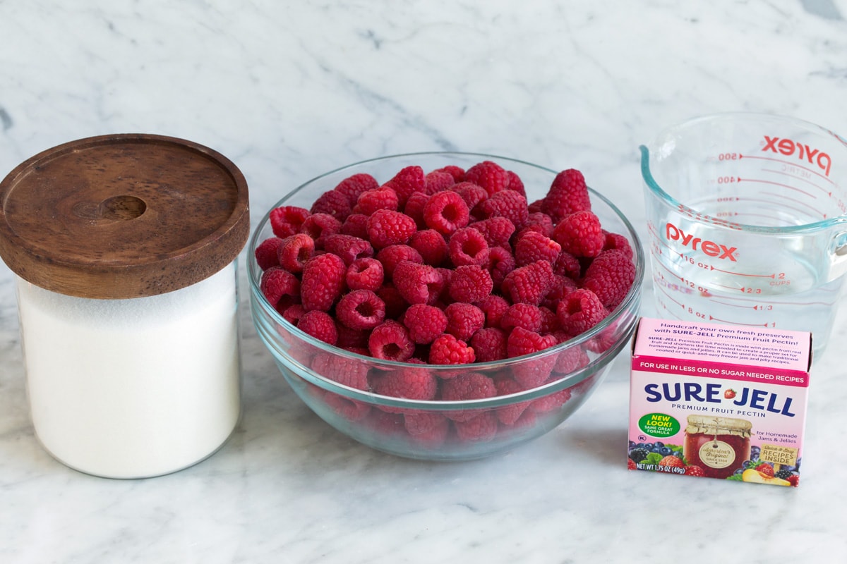 Easy Homemade Raspberry Freezer Jam - no canning skills or equipment required! This is my all time favorite jam! I've been making it for 10+years, it's the only jam I make now. Everyone always loves it and it freezes for up to 1 year! #jam #freezerjam #homeamdejam #easyrecipe Ingredients needed to make raspberry jam.