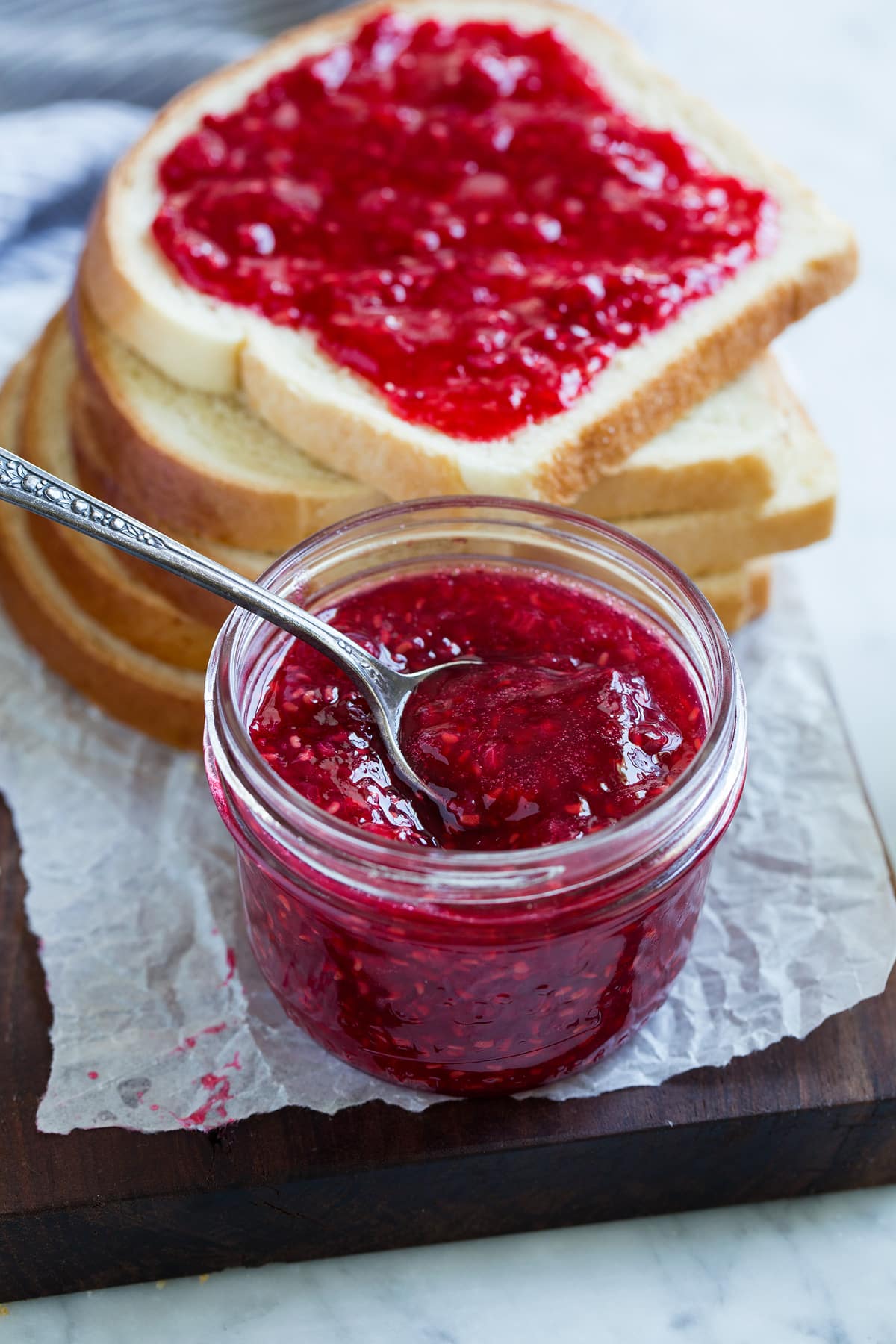 Easy Homemade Raspberry Freezer Jam - no canning skills or equipment required! This is my all time favorite jam! I've been making it for 10+years, it's the only jam I make now. Everyone always loves it and it freezes for up to 1 year! #jam #freezerjam #homeamdejam #easyrecipe Close up image of raspberry jam.